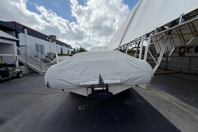  Yacht Photos Pics 2023 Williams Jet Tenders Dieseljet 625 covered, parked outdoors under a cloudy sky.