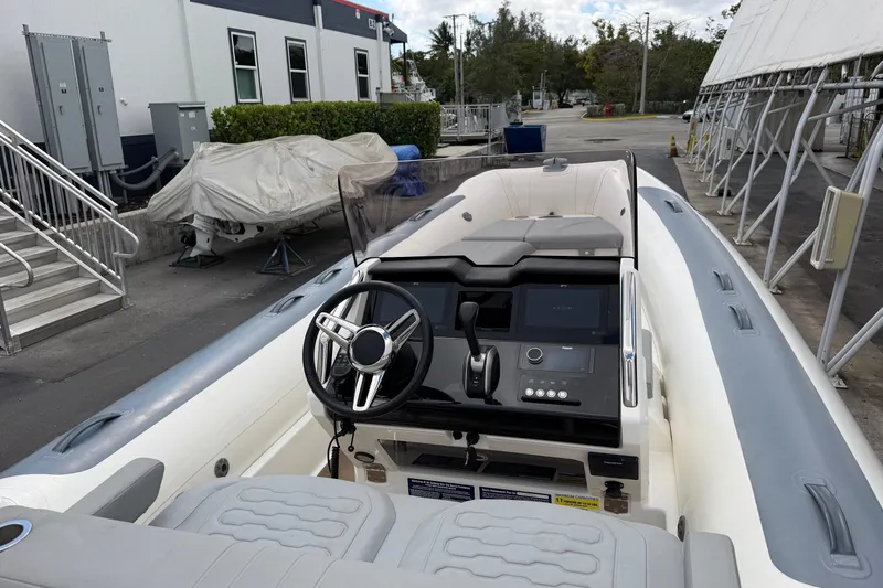  Yacht Photos Pics 2023 Williams Jet Tenders Dieseljet 625 boat interior with steering wheel and control panel.