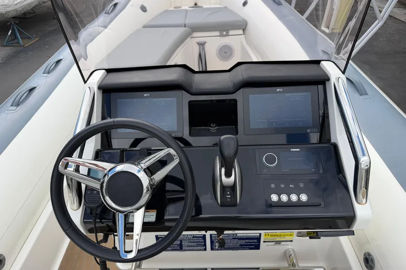  Yacht Photos Pics 2023 Williams Jet Tenders Dieseljet 625 dashboard with steering wheel and control panel.