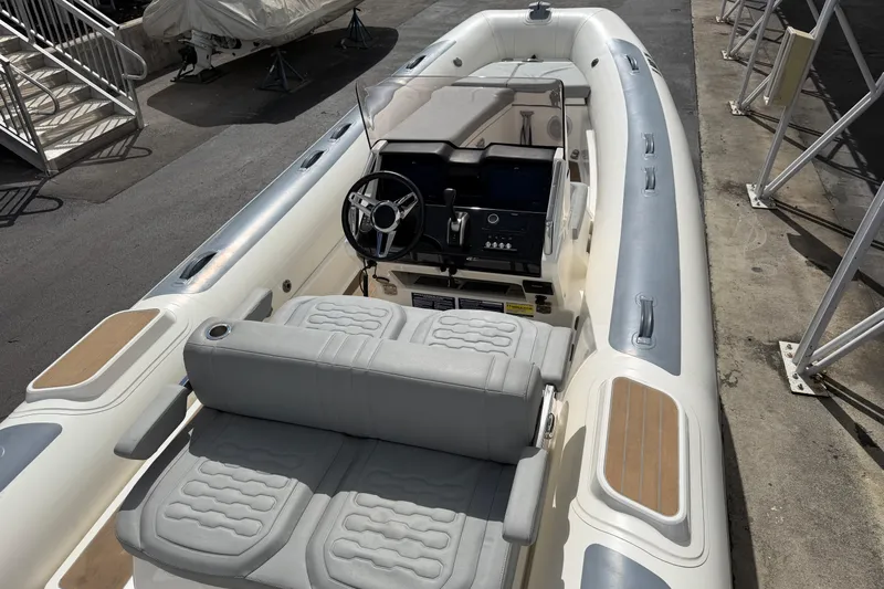  Yacht Photos Pics 2023 Williams Jet Tenders Dieseljet 625 boat interior with steering console and seating.