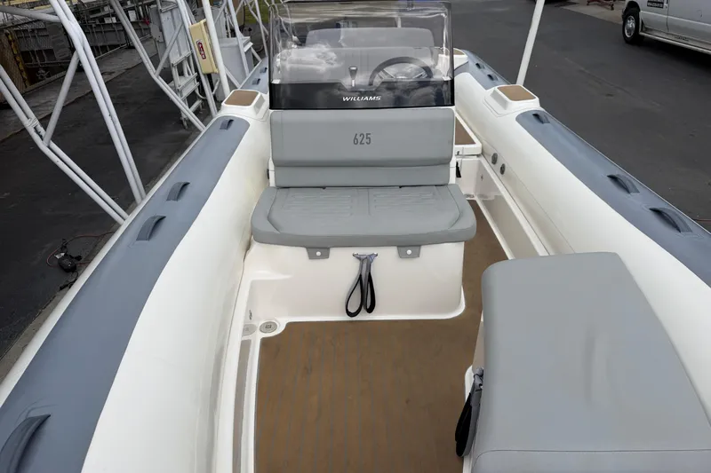  Yacht Photos Pics 2023 Williams Jet Tenders Dieseljet 625 boat interior with seating and steering console.