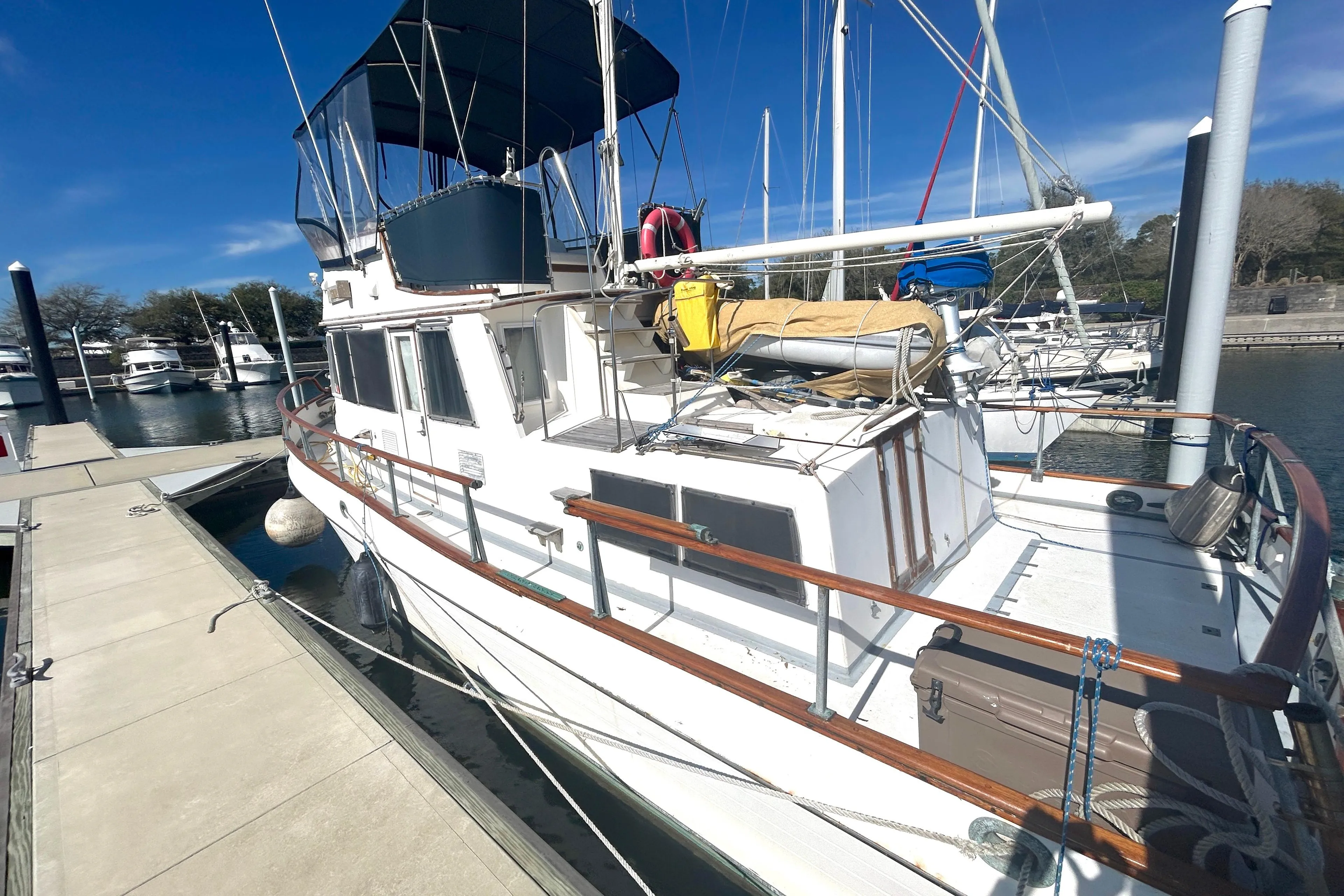 1988 Grand Banks 36 Classic yacht docked at marina under clear blue sky.
