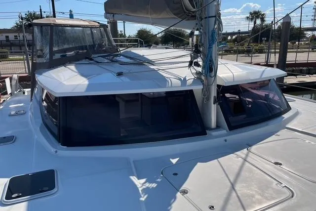 Akua Yacht Photos Pics 2018 Fountaine Pajot Helia 44 Evolution catamaran docked, showcasing sleek design and spacious deck.