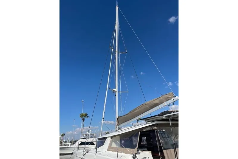 Akua Yacht Photos Pics 2018 Fountaine Pajot Helia 44 Evolution catamaran with sails, docked under clear blue sky.
