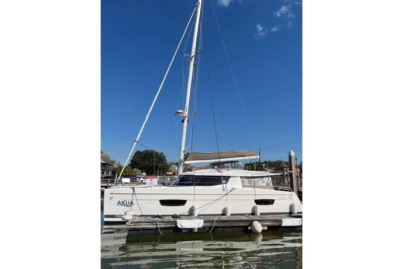 Akua Yacht Photos Pics 2018 Fountaine Pajot Helia 44 Evolution catamaran docked under clear blue sky.