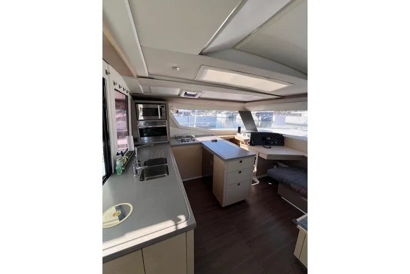 Akua Yacht Photos Pics Interior of 2018 Fountaine Pajot Helia 44 Evolution catamaran, featuring modern kitchen and navigation area.