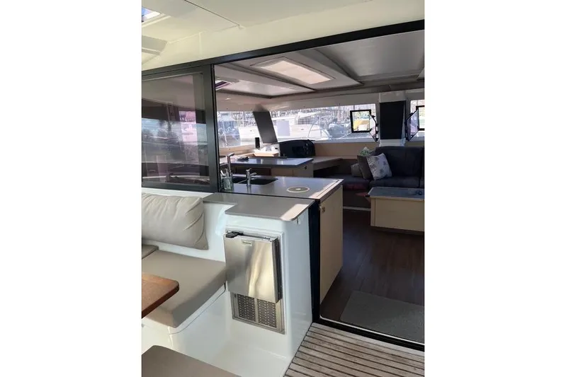 Akua Yacht Photos Pics Interior view of 2018 Fountaine Pajot Helia 44 Evolution catamaran, featuring modern seating and kitchen area.