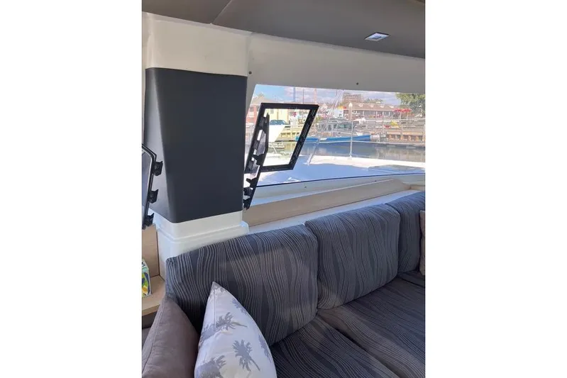 Akua Yacht Photos Pics Interior view of 2018 Fountaine Pajot Helia 44 Evolution catamaran with striped seating and window.