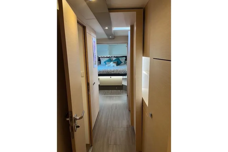 Akua Yacht Photos Pics Interior hallway of 2018 Fountaine Pajot Helia 44 Evolution catamaran, leading to a cozy bedroom.