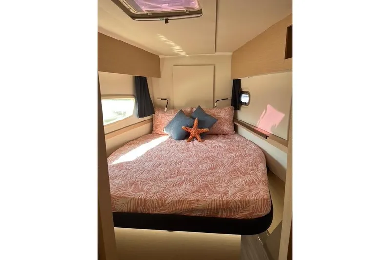 Akua Yacht Photos Pics 2018 Fountaine Pajot Helia 44 Evolution cabin with cozy bed and decorative pillows.