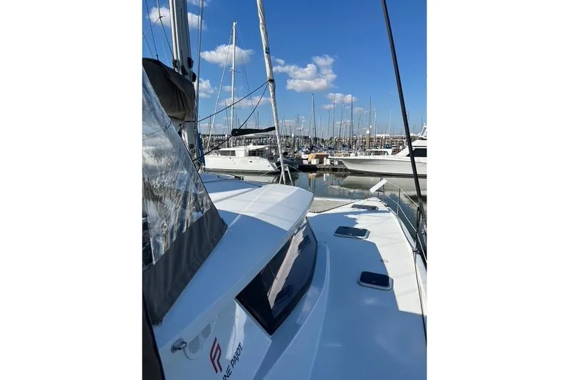 Akua Yacht Photos Pics 2018 Fountaine Pajot Helia 44 Evolution catamaran docked in a marina under blue skies.