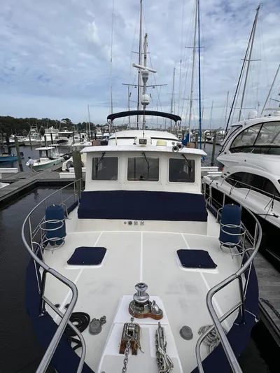 Dyer Need Yacht Photos Pics Kadey-Krogen 48 yacht from 1996 docked at a marina, surrounded by other boats.