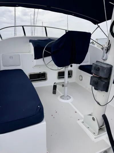 Dyer Need Yacht Photos Pics Helm area of 1996 Kadey-Krogen 48 yacht with blue seating and steering wheel.