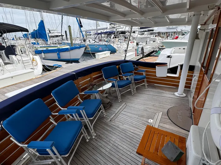Dyer Need Yacht Photos Pics Deck of 1996 Kadey-Krogen 48 yacht with blue chairs and marina view.