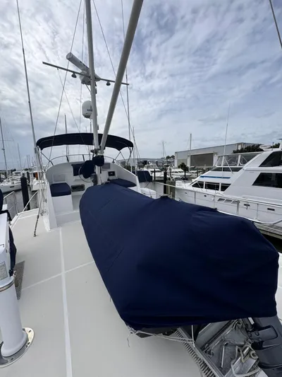 Dyer Need Yacht Photos Pics Kadey-Krogen 48 yacht, 1996 model, docked with covered equipment on deck.