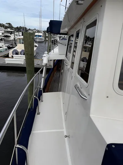 Dyer Need Yacht Photos Pics Kadey-Krogen 48 yacht, 1996 model, docked at a marina with visible walkway and railing.