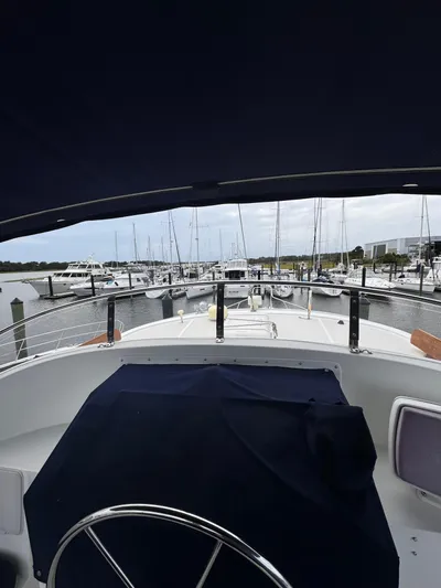 Dyer Need Yacht Photos Pics Kadey-Krogen 48 yacht, 1996 model, docked in a marina with multiple sailboats.