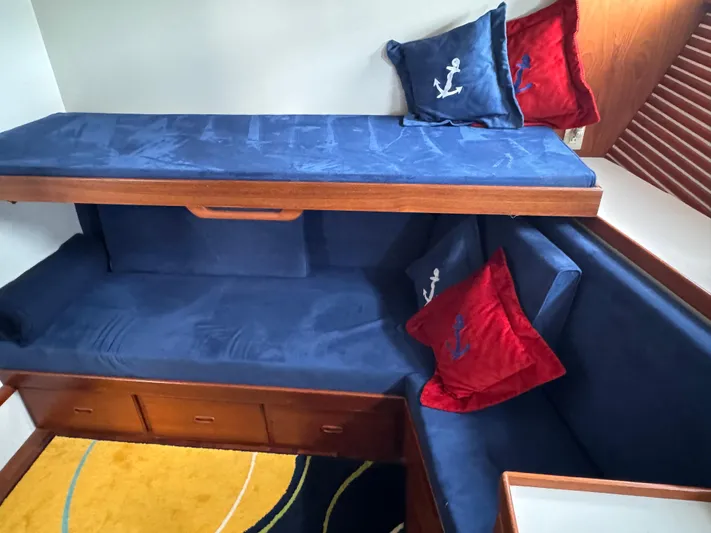 Dyer Need Yacht Photos Pics Cozy cabin interior of 1996 Kadey-Krogen 48 with blue and red nautical-themed cushions.