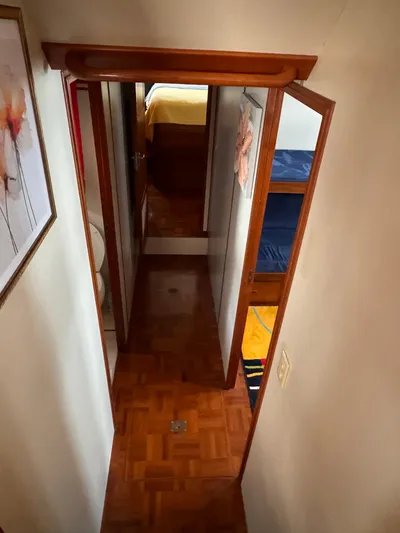 Dyer Need Yacht Photos Pics Narrow hallway inside 1996 Kadey-Krogen 48 yacht with wooden flooring and cabin doors.