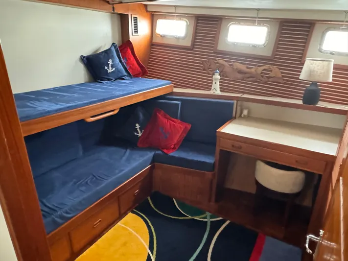 Dyer Need Yacht Photos Pics Cozy cabin interior of 1996 Kadey-Krogen 48 with bunk beds and nautical decor.