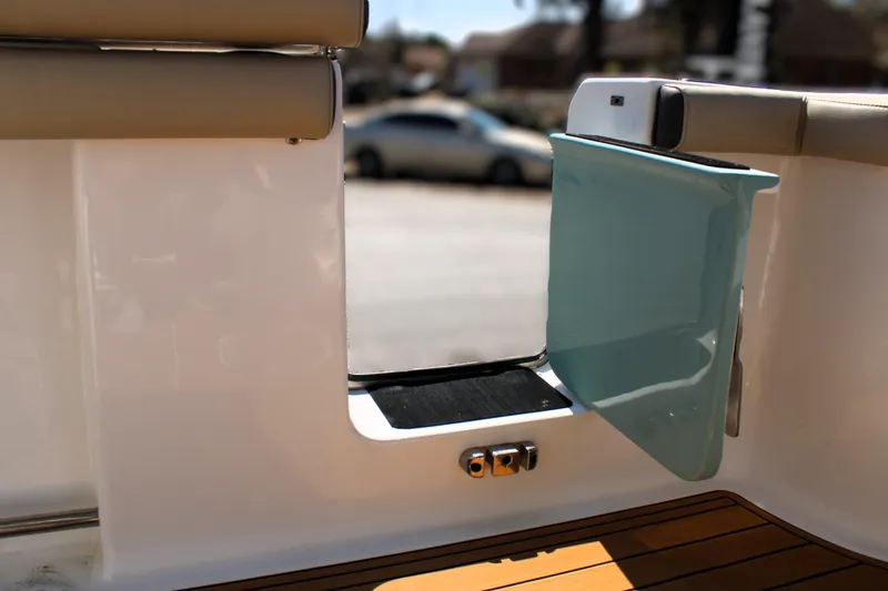  Yacht Photos Pics 2022 Tidewater 272 CC Adventure boat with open side door and teak flooring.