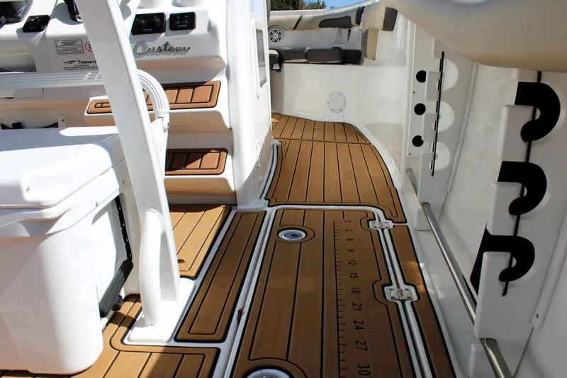  Yacht Photos Pics 2022 Tidewater 272 CC Adventure boat interior with teak flooring and modern design features.