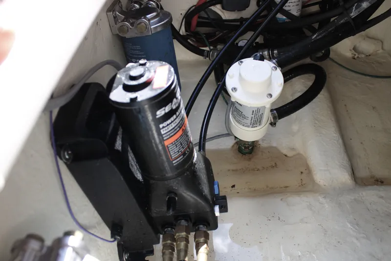  Yacht Photos Pics 2022 Tidewater 272 CC Adventure boat engine compartment with hydraulic and fuel components.