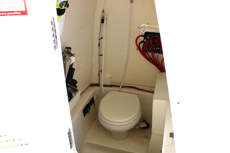  Yacht Photos Pics 2022 Tidewater 272 CC Adventure boat interior with compact marine toilet.