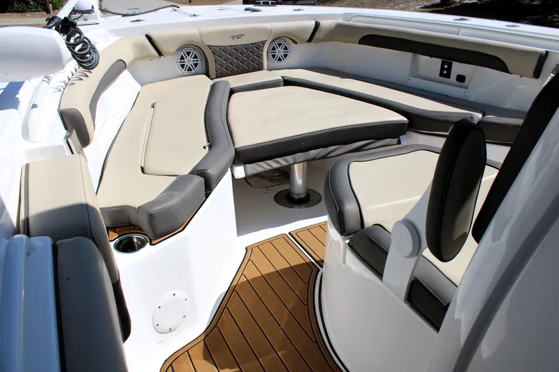 Yacht Photos Pics 2022 Tidewater 272 CC Adventure boat interior with cushioned seating and teak flooring.
