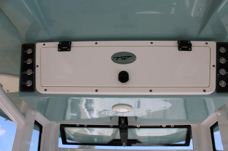  Yacht Photos Pics 2022 Tidewater 272 CC Adventure boat console with control panel and storage compartment.