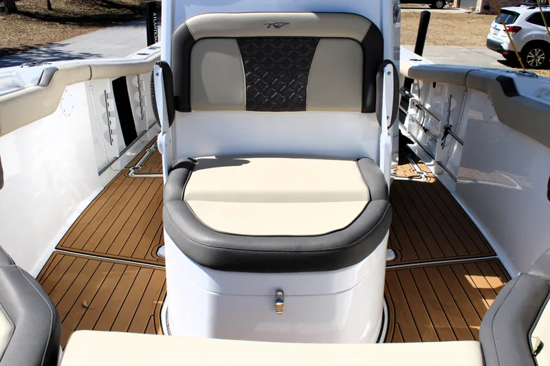  Yacht Photos Pics 2022 Tidewater 272 CC Adventure boat interior with cushioned seating and teak flooring.