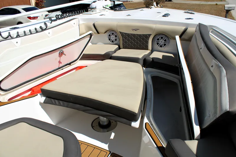  Yacht Photos Pics 2022 Tidewater 272 CC Adventure boat interior with cushioned seating and storage compartments.