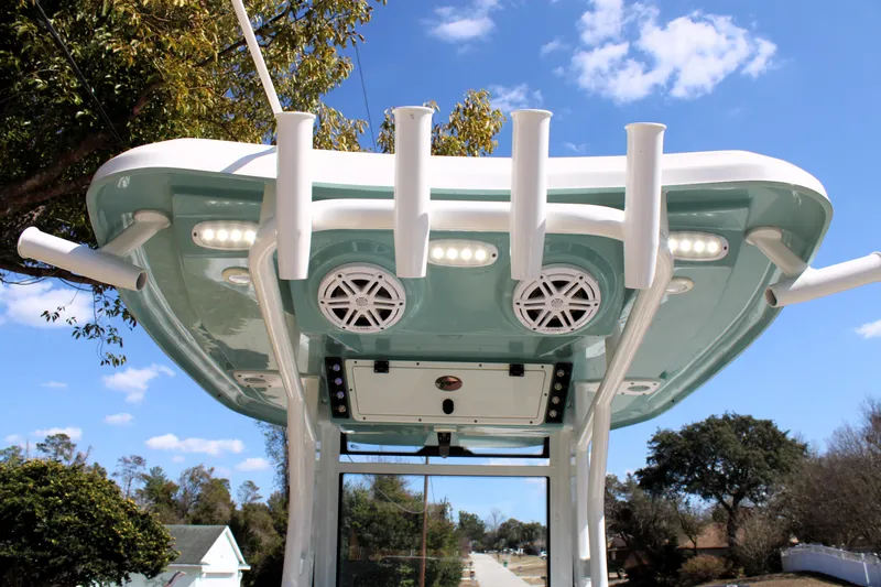  Yacht Photos Pics 2022 Tidewater 272 CC Adventure boat with rod holders and speakers under a clear blue sky.