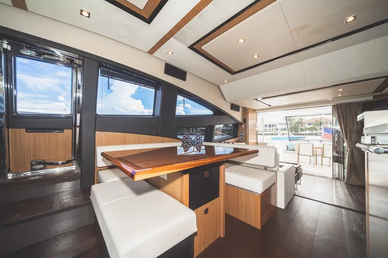  Yacht Photos Pics Luxurious interior of 2017 Sea Ray L650 Fly yacht with elegant dining area and scenic views.
