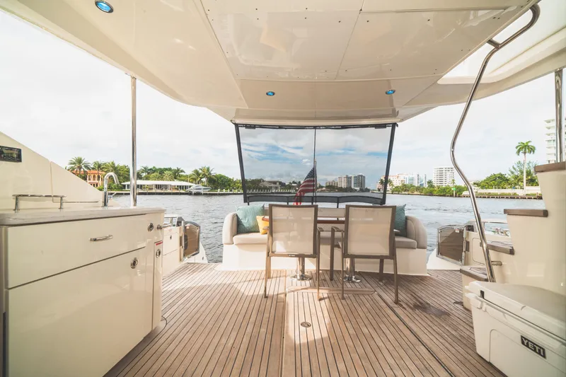  Yacht Photos Pics Luxurious 2017 Sea Ray L650 Fly yacht deck with seating, table, and waterfront view.
