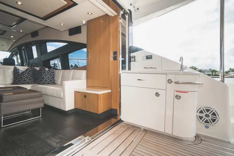  Yacht Photos Pics Luxurious interior of 2017 Sea Ray L650 Fly yacht with modern seating and kitchenette.