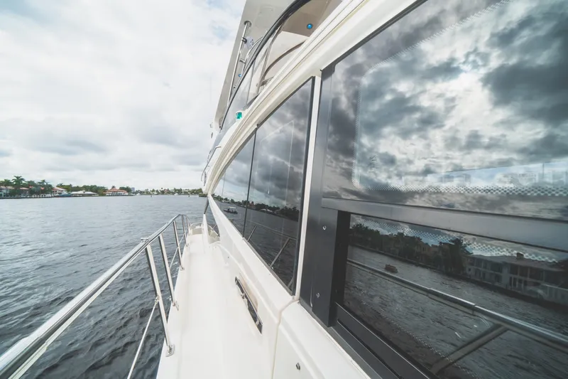  Yacht Photos Pics 2017 Sea Ray L650 Fly yacht reflecting cloudy sky on calm waters.