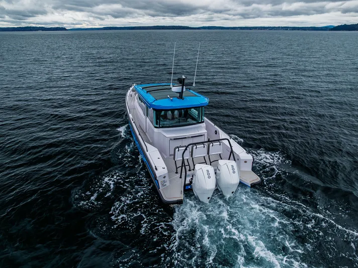 Aqvavit Yacht Photos Pics 2021 Axopar 37xc Wetbar cruising on open water under cloudy skies.