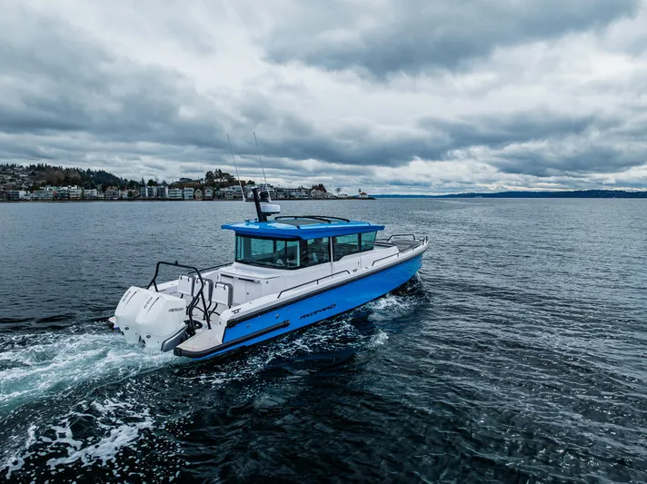 Aqvavit Yacht Photos Pics 2021 Axopar 37xc Wetbar cruising on a cloudy day in open water.