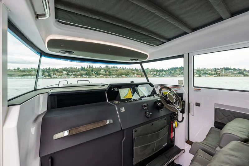 Aqvavit Yacht Photos Pics 2021 Axopar 37xc Wetbar interior with modern helm and panoramic windows.