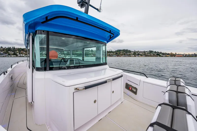 Aqvavit Yacht Photos Pics 2021 Axopar 37xc Wetbar boat with sleek design on calm waters.