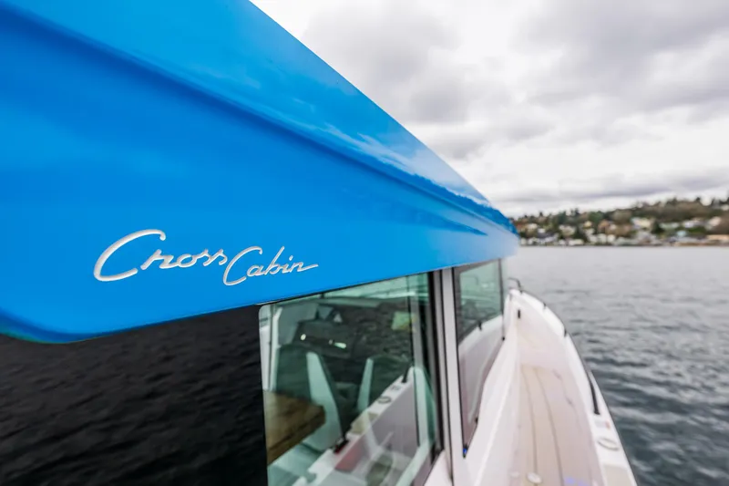 Aqvavit Yacht Photos Pics 2021 Axopar 37xc Wetbar boat with blue Cross Cabin detail on water.