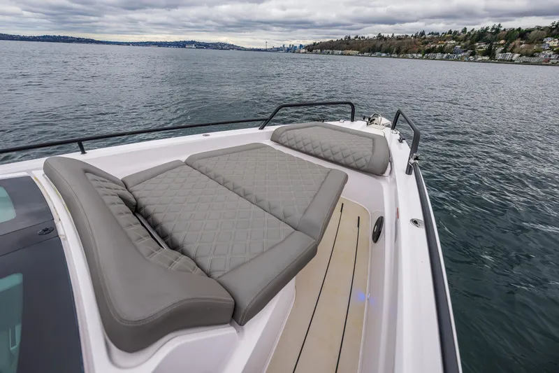 Aqvavit Yacht Photos Pics 2021 Axopar 37xc Wetbar boat with cushioned deck, on a calm lake.