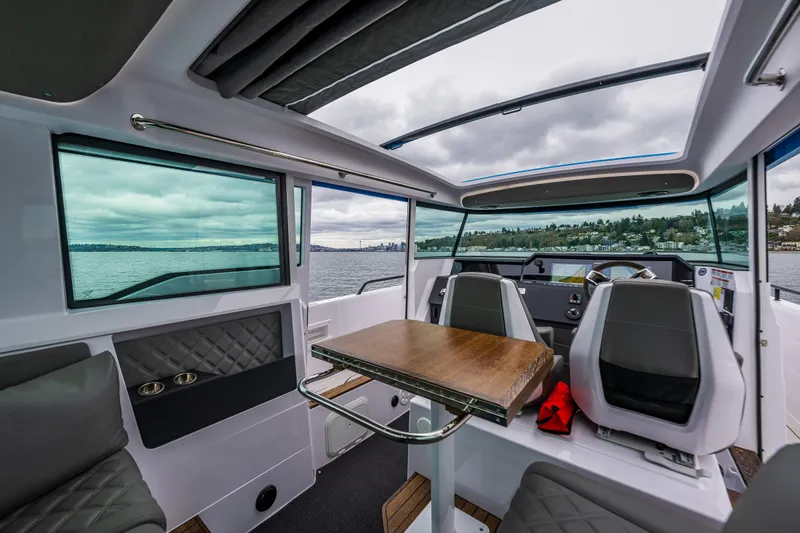 Aqvavit Yacht Photos Pics Interior of 2021 Axopar 37xc Wetbar boat with modern seating and panoramic windows.