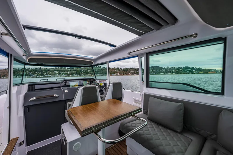 Aqvavit Yacht Photos Pics Interior of 2021 Axopar 37xc Wetbar boat with seating and water view.