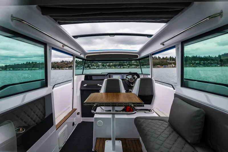 Aqvavit Yacht Photos Pics Interior of 2021 Axopar 37xc Wetbar boat with modern seating and panoramic windows.
