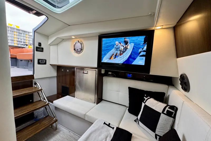 Yacht Photos Pics Luxurious interior of 2022 Cruisers Yachts 338 South Beach Edition Bow Rider with TV and seating.