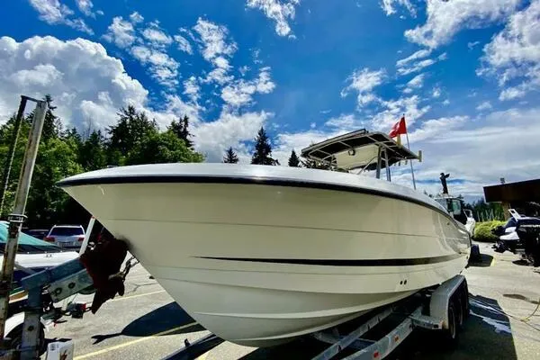  Yacht Photos Pics 2002 Hydra-Sports 2796 CC Vector boat on trailer under a vibrant blue sky.