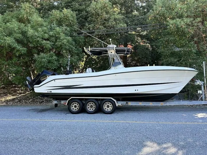  Yacht Photos Pics 2002 Hydra-Sports 2796 CC Vector boat on trailer, parked on a road.