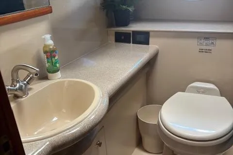  Yacht Photos Pics 2004 Cruisers Yachts 370 Express bathroom with sink, toilet, and countertop.